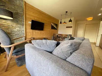 a living room with a couch and chairs and a television at Appartement lumineux avec terrasse et parking à Samoëns - FR-1-624-171 in Samoëns