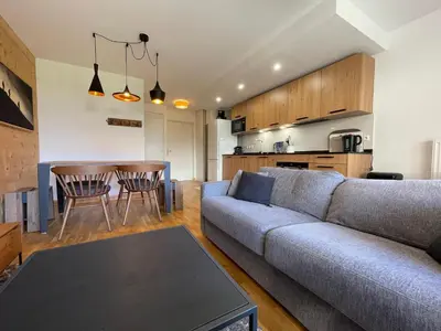 a living room with a couch and a table at Appartement lumineux avec terrasse et parking à Samoëns - FR-1-624-171 in Samoëns