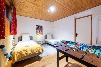 a room with a pool table and a bed at Appartement des Cristaux - Welkeys in Megève