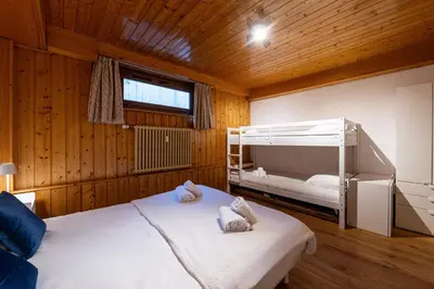 a bedroom with two bunk beds and a window at Appartement des Cristaux - Welkeys in Megève