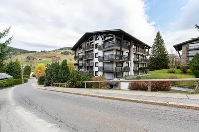 an apartment building on the side of a road at Appartement des Cristaux - Welkeys in Megève