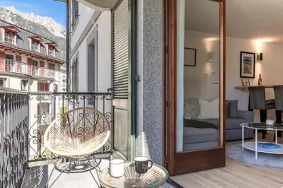 a balcony with a chair and a room with a bed at Bel Oiseau - Hypercentre - Balcon -Chamonix in Chamonix-Mont-Blanc