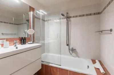 a bathroom with a shower and a tub and a sink at Bel Oiseau - Hypercentre - Balcon -Chamonix in Chamonix-Mont-Blanc