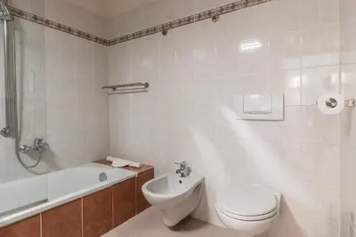 a bathroom with a toilet and a sink and a tub at Bel Oiseau - Hypercentre - Balcon -Chamonix in Chamonix-Mont-Blanc