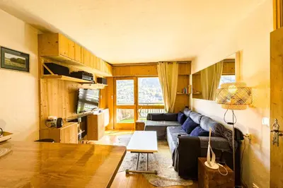 a living room with a couch and a table at Apartment with mountain view in Saint-Gervais in Saint-Gervais-les-Bains
