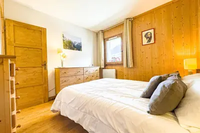 a bedroom with a large bed and a window at Apartment with mountain view in Saint-Gervais in Saint-Gervais-les-Bains