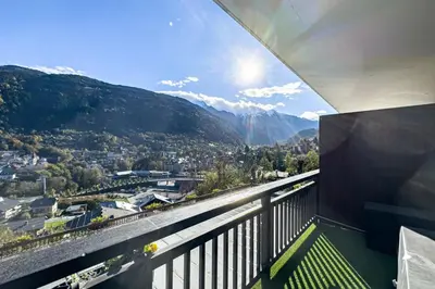 a balcony with a view of a city and mountains at Apartment with mountain view in Saint-Gervais in Saint-Gervais-les-Bains