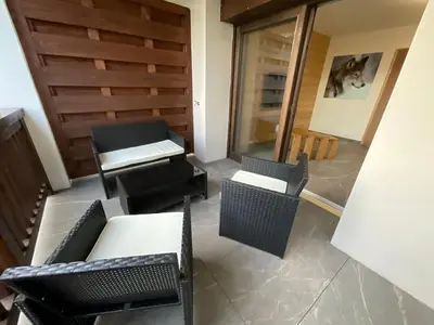 a room with chairs and tables and a sliding glass door at Le Manoir d Ernesta in Passy