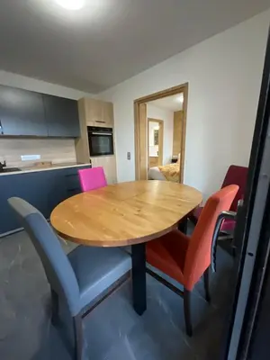 a wooden table and chairs in a room at Le Manoir d Ernesta in Passy