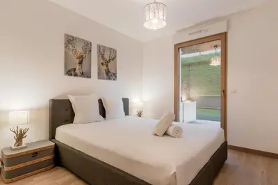 a bedroom with a large white bed and a window at Le 002 - Proche Telecabine - Terrasse in Saint-Gervais-les-Bains
