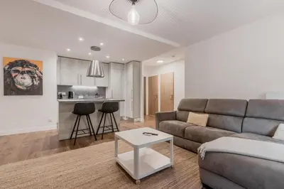 a living room with a couch and a table at Le 002 - Proche Telecabine - Terrasse in Saint-Gervais-les-Bains
