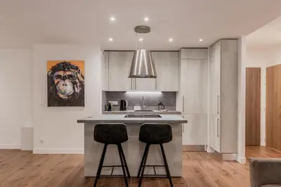 a kitchen with a island with two bar stools at Le 002 - Proche Telecabine - Terrasse in Saint-Gervais-les-Bains