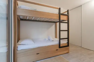 a bunk bed with a ladder in a room at Le 002 - Proche Telecabine - Terrasse in Saint-Gervais-les-Bains