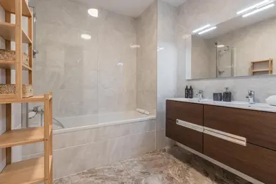a bathroom with a tub and a sink at Le 002 - Proche Telecabine - Terrasse in Saint-Gervais-les-Bains
