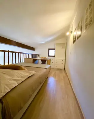 a bedroom with two beds and a table at Le coin cosy des 4 têtes - balcon - vue montagnes - proche centre & gare in Sallanches