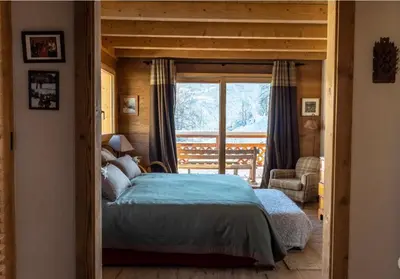 a bedroom with a bed and a large window at Chalet prestige Saint Gervais les Bains in Saint-Gervais-les-Bains