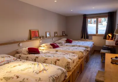 a group of four beds in a room at Chalet prestige Saint Gervais les Bains in Saint-Gervais-les-Bains