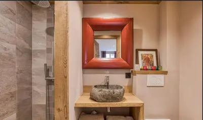 a bathroom with a sink and a mirror at Chalet prestige Saint Gervais les Bains in Saint-Gervais-les-Bains