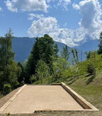 a parking lot with a snow covered mountain in the background at Chalet prestige Saint Gervais les Bains in Saint-Gervais-les-Bains
