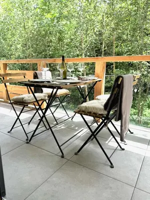 a table and two chairs on a patio at Les cimes de l alpage - Duplex luxe 130 m2 au pied des pistes in Combloux