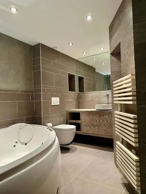 a bathroom with a tub and a toilet and a sink at Marmotte Mountain Pic Vert in Chamonix-Mont-Blanc