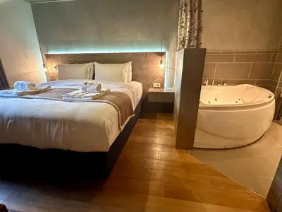 a bedroom with a bed and a bath tub at Marmotte Mountain Pic Vert in Chamonix-Mont-Blanc