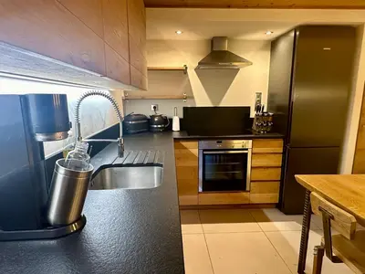 a kitchen with a sink and a refrigerator at Marmotte Mountain Pic Vert in Chamonix-Mont-Blanc