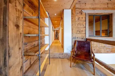 a room with a wooden wall and a wooden chair at Marmotte Mountain Pic Vert in Chamonix-Mont-Blanc