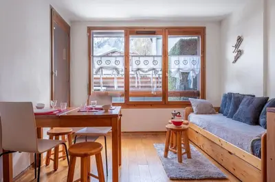 a living room with a couch and a table at Delice - City center Les Houches & Free Parking - By Cozee Rentals in Les Houches