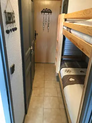 a hallway with a bunk bed in a room at STUDIO POINTE DES ARAVIS 4 PERS HTE-SAVOIE in Saint-Gervais-les-Bains