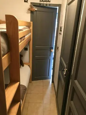 a hallway with a door and a room with a bunk bed at STUDIO POINTE DES ARAVIS 4 PERS HTE-SAVOIE in Saint-Gervais-les-Bains