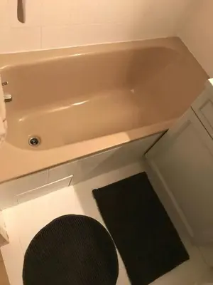 a bath tub in a bathroom with a black rug at STUDIO POINTE DES ARAVIS 4 PERS HTE-SAVOIE in Saint-Gervais-les-Bains