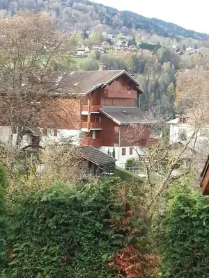a large brick building in the middle of a village at STUDIO POINTE DES ARAVIS 4 PERS HTE-SAVOIE in Saint-Gervais-les-Bains