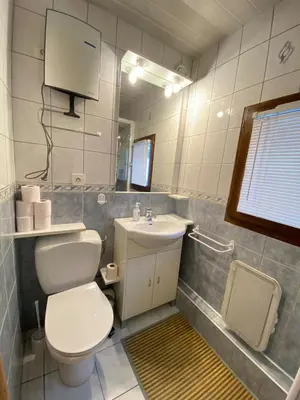 a bathroom with a white toilet and a sink at Studio in Arâches-la-Frasse