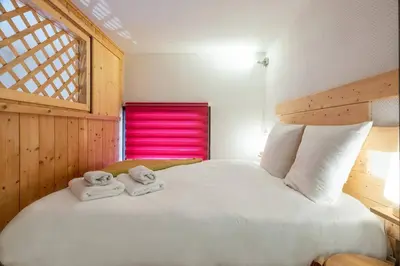 a living room with a couch and a table at Ancolie - Apartment Free parking close to ski lift - By Cozee Rentals in Chamonix-Mont-Blanc