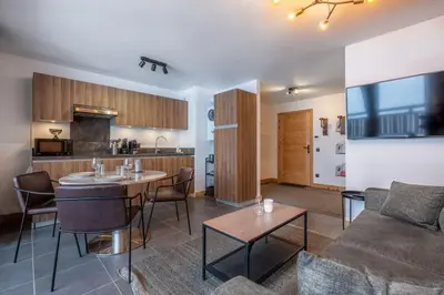 a living room with a couch and a table at Le Freney - New Apartment in Town Center & Free parking - By Cozee Rentals in Les Houches