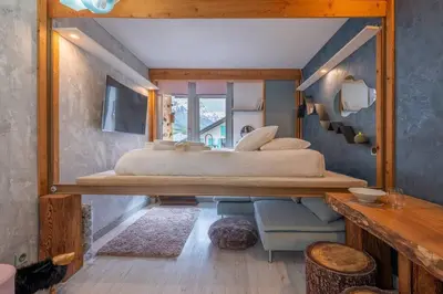 a bedroom with a large bed and a mirror at Lognan- New studio in the city center - By Cozee Rentals in Chamonix-Mont-Blanc