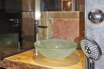a green bowl on a counter in a bathroom at Lognan- New studio in the city center - By Cozee Rentals in Chamonix-Mont-Blanc
