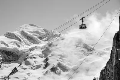 a ski lift in front of a snow covered mountain at Prarion - Modern apartment Next to Ski lift - By Cozee Rentals in Les Houches