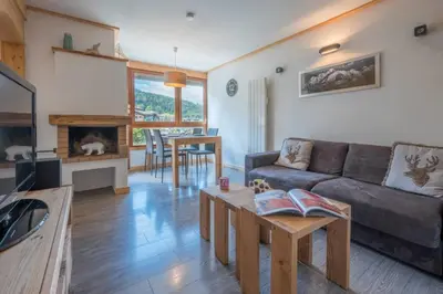 a living room with a couch and a table at Prarion - Modern apartment Next to Ski lift - By Cozee Rentals in Les Houches