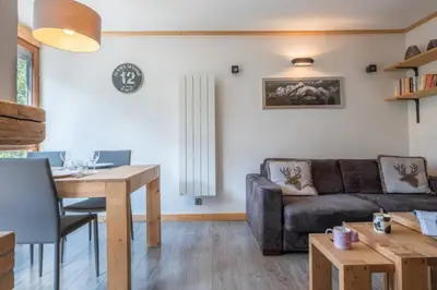 a living room with a couch and a table at Prarion - Modern apartment Next to Ski lift - By Cozee Rentals in Les Houches