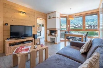 a living room with a couch and a tv at Prarion - Modern apartment Next to Ski lift - By Cozee Rentals in Les Houches