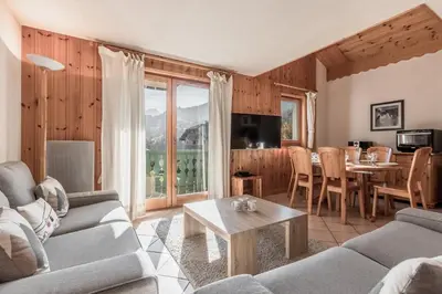 a living room with a couch and a table at Appartement Edelweiss in Saint-Gervais-les-Bains
