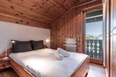 a bedroom with a large bed with a large window at Appartement Edelweiss in Saint-Gervais-les-Bains