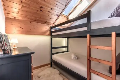 a bunk bed room with two bunk beds and a desk at Appartement Edelweiss in Saint-Gervais-les-Bains