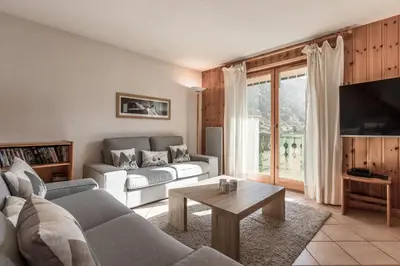 a living room with a couch and a table at Appartement Edelweiss in Saint-Gervais-les-Bains