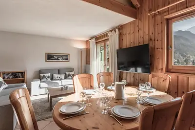 a dining room with a table and chairs and a couch at Appartement Edelweiss in Saint-Gervais-les-Bains