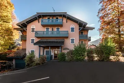 a large pink building with a balcony on top of it at Appartement Edelweiss in Saint-Gervais-les-Bains