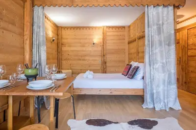 a wooden room with a bed and a table at Prarion - Modern apartment 4 pax Next to Ski lift - By Cozee Rentals in Les Houches