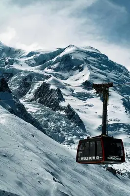 a ski lift on top of a snow covered mountain at Prarion - Modern apartment 4 pax Next to Ski lift - By Cozee Rentals in Les Houches